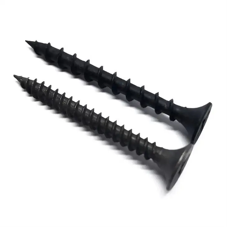 Worker installing drywall screws with drill